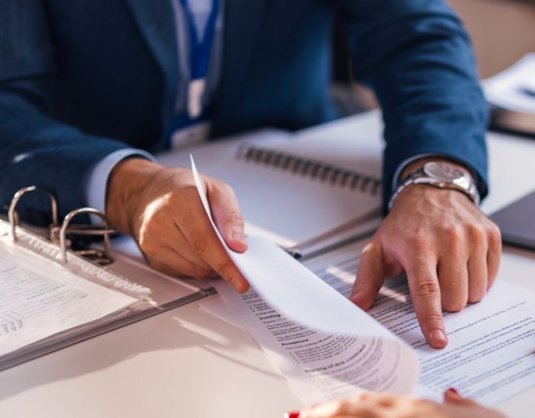 Business consultant reviewing financial and strategic planning documents during consulting services in Ermionida Greece.
